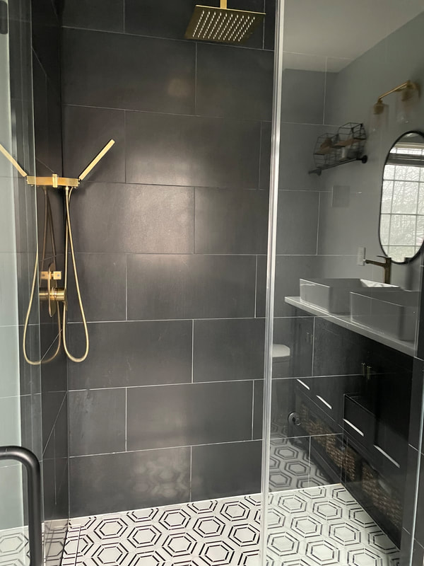 Slate tile master shower with brass fixtures